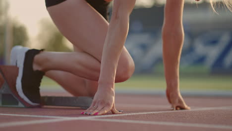 Female-athlete-starting-her-sprint-on-a-running-track.-Runner-taking-off-from-the-starting-blocks-on-running-track.-Young-woman-athlete-start-running-from-block.-Slow-motion
